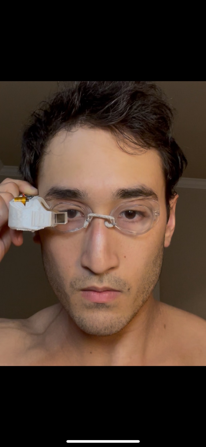 Sam wearing and adjusting an early movie-goggle prototype