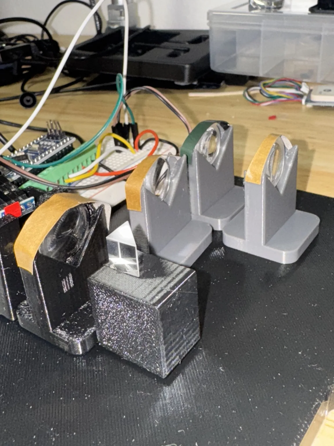Adjustable lens holders and beam-splitting optics