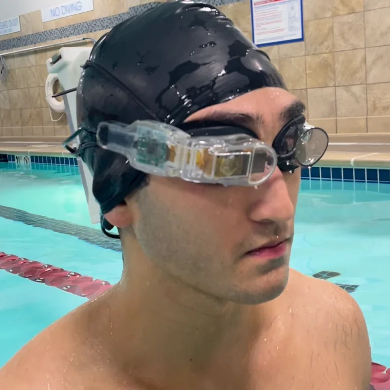 Sam wearing the transparent movie-goggle prototype at the pool