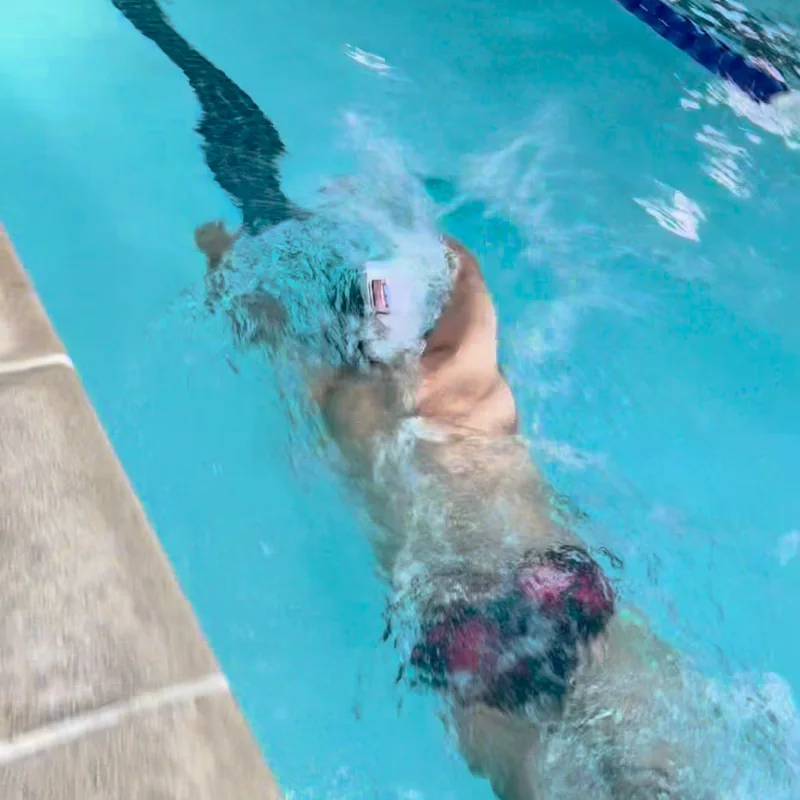 Sam swimming a lap while wearing the movie-goggle prototype